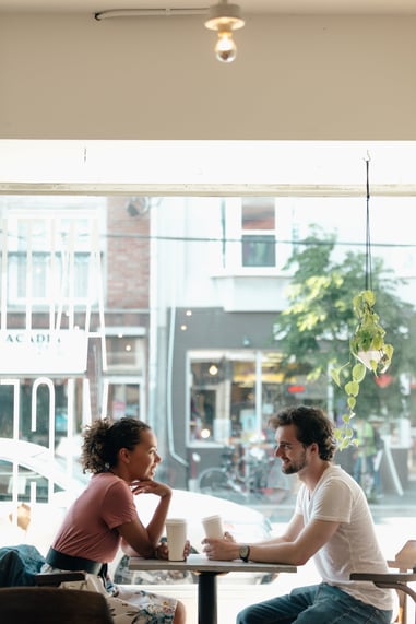 a-man-and-a-woman-are-framed-against-a-sunny-window