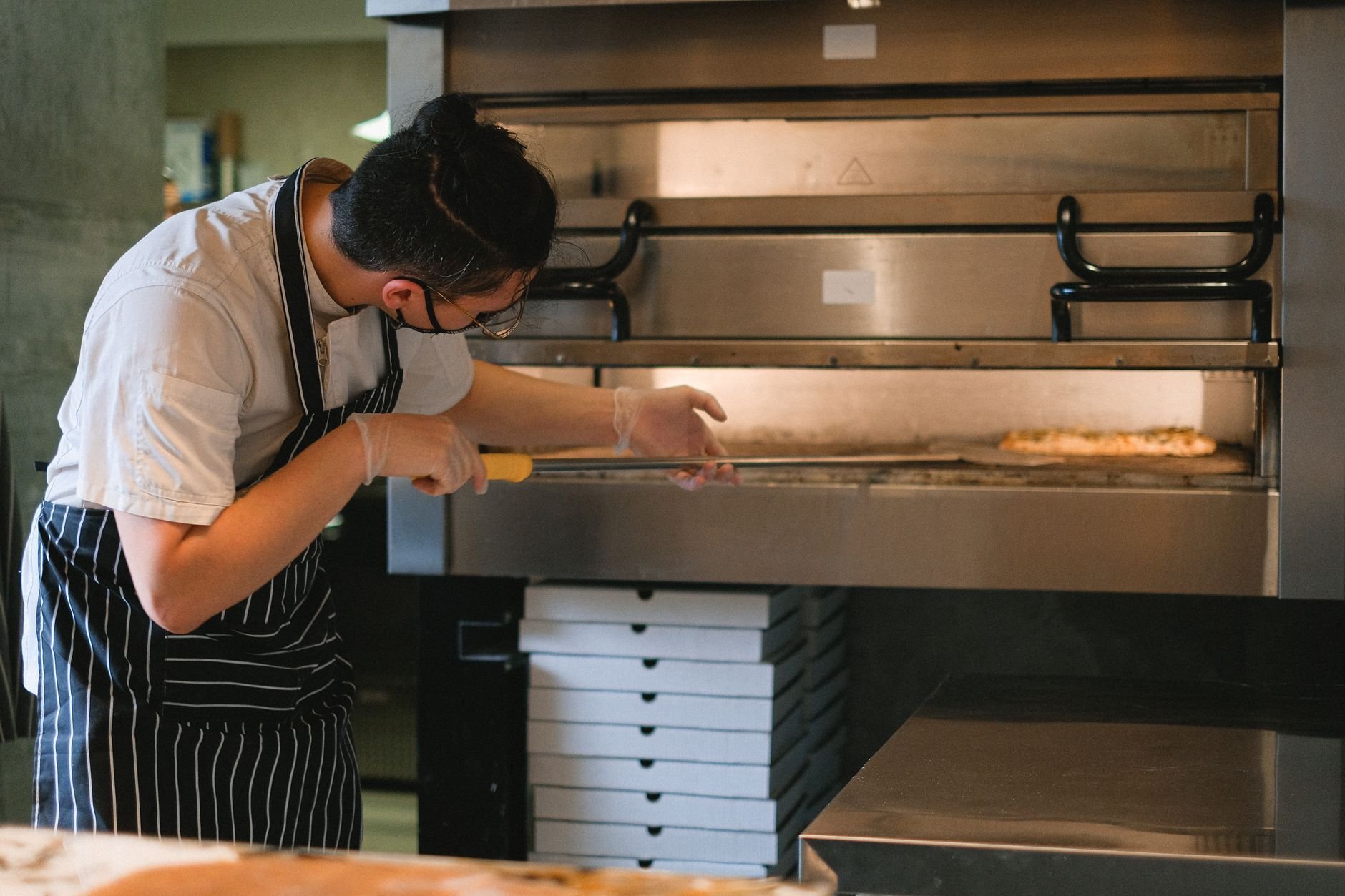 chef-slides-pizza-into-oven