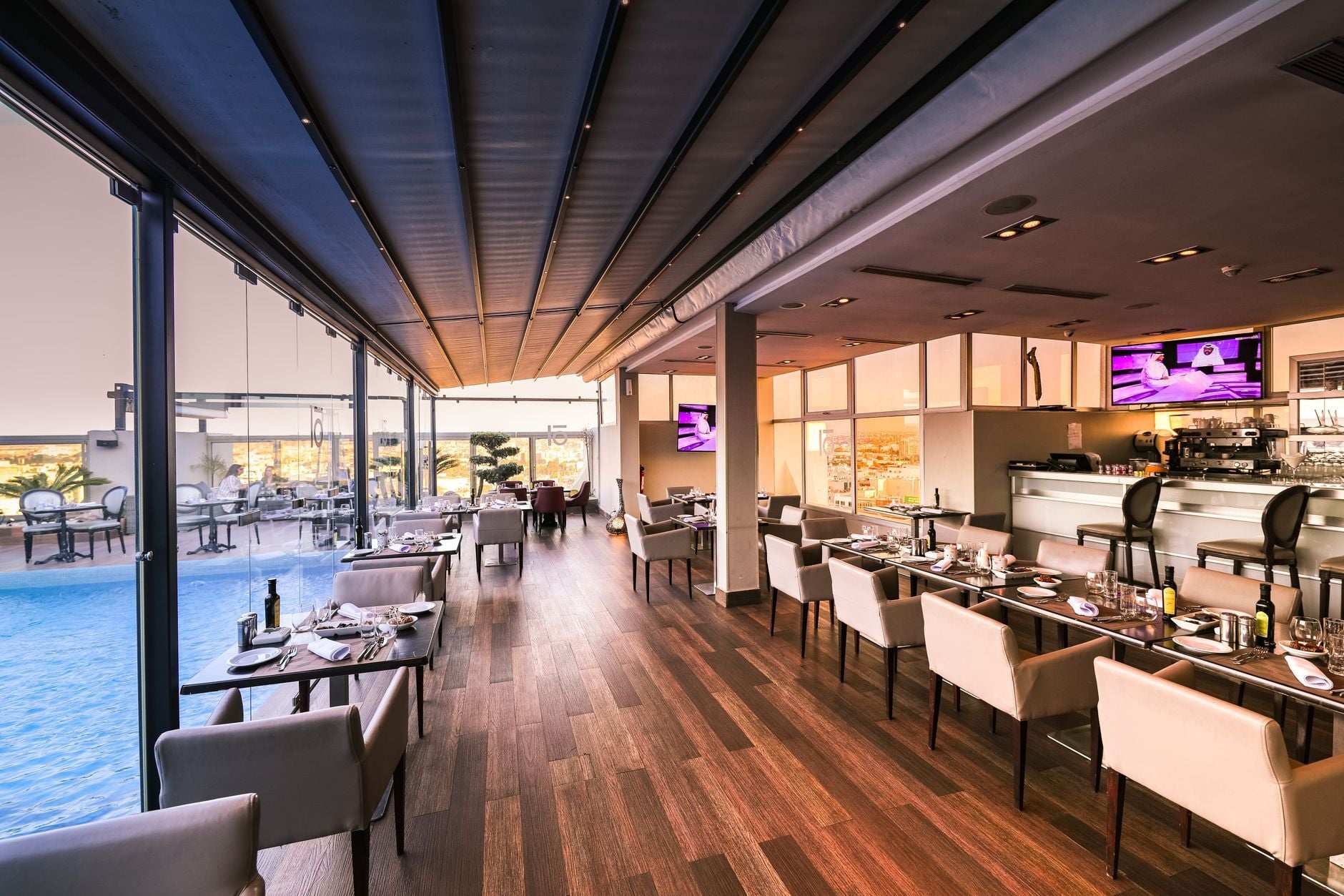 Spacious modern restaurant interior with a poolside view. Photo by Zak Chapman on Pexels